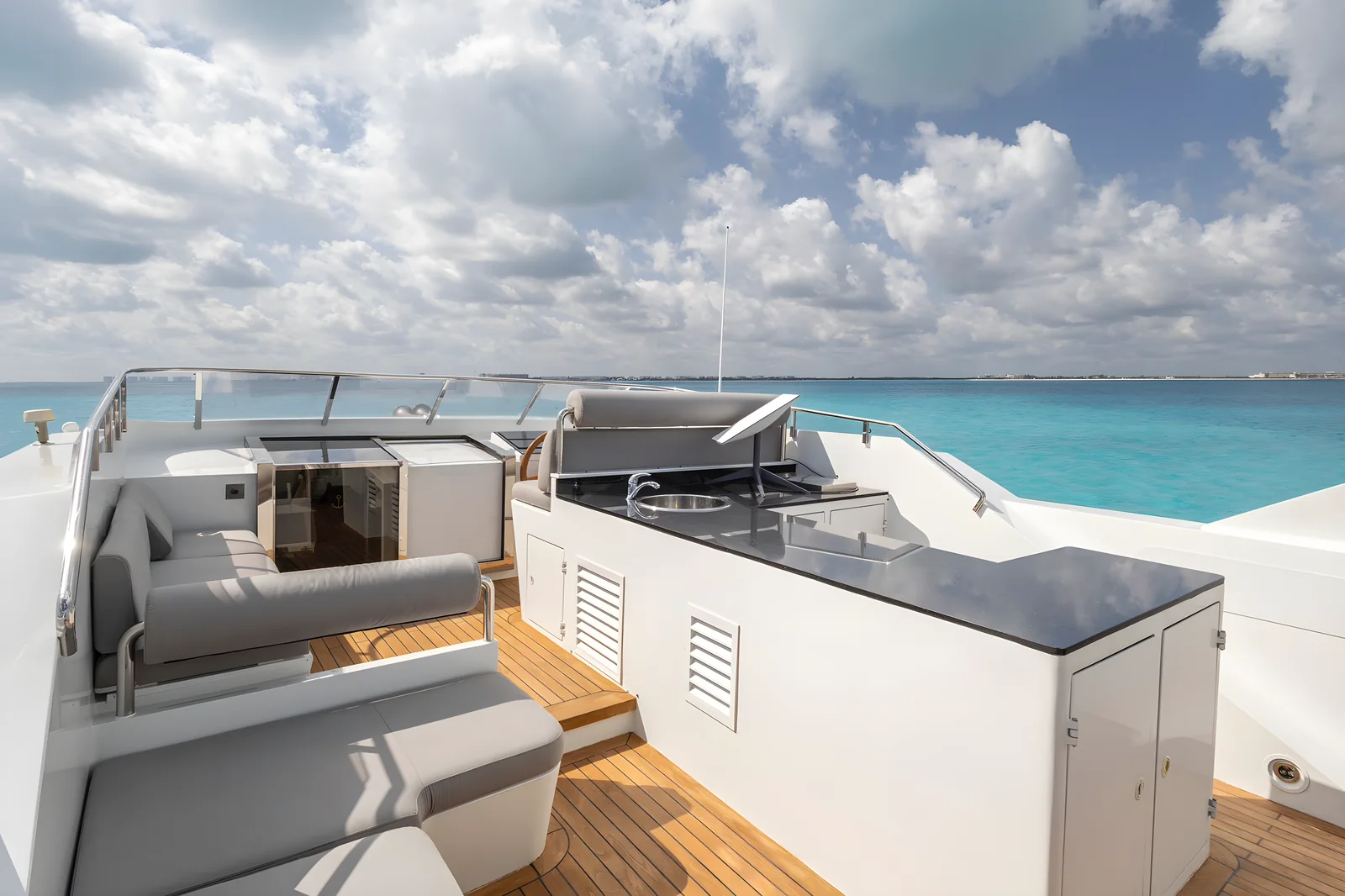 Bar y lounge de la flybridge del yate Avalon 115ft con vistas al mar.