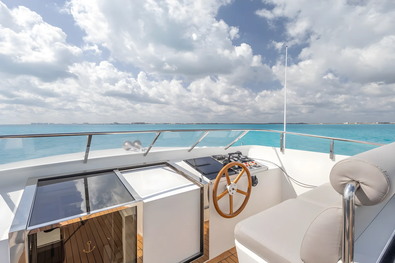 Puesto de mando del yate Avalon 115ft con timón de madera y vistas al mar.