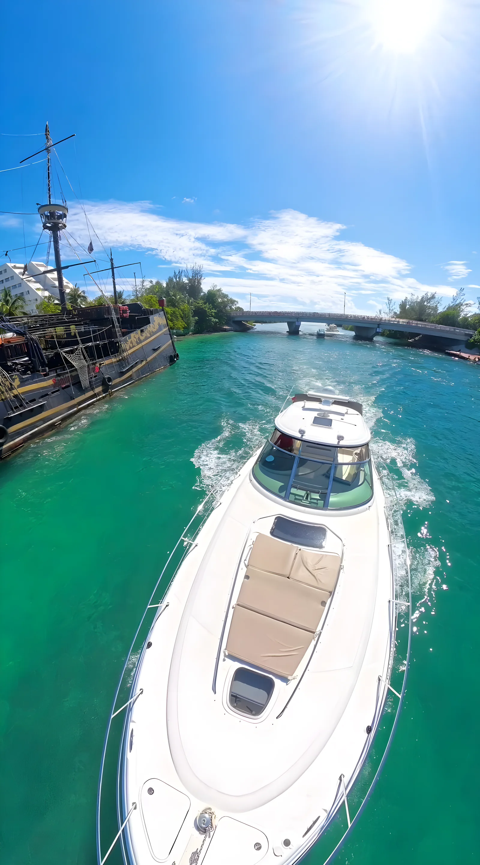 Vista aérea del yate Dolphin de 48 pies navegando por un canal junto a un barco pirata.